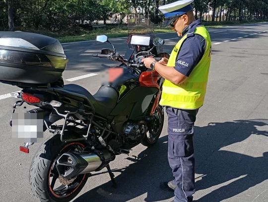 policjant stoi koło motocykla